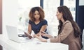 Using online resources for a team task. two businesswomen using a digital tablet together during a collaboration at work Royalty Free Stock Photo