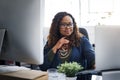 Using online resources to boost business. a young businesswoman using a laptop at her desk in a modern office. Royalty Free Stock Photo