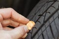 Using a penny to check tread depth on a tire