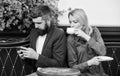 Using phone while date. Morning coffee. woman and man with beard relax in cafe. Couple in love on romantic date. Brutal Royalty Free Stock Photo