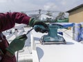 Using a Ponceuse Vibrante or Orbital Sander to scrub surface intermediate fire proof paint before painting top coat Royalty Free Stock Photo