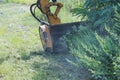 Using professional tractor mechanical mower utility worker is mowing tall grass along the side of highway