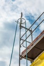 Using pulley for house renovation with scaffold pole platform Royalty Free Stock Photo