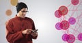 Using smartphone, man in beanie exploring digital interfaces concept in school