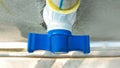 Using stop valve for pvc pipe fittings In Water pipeline attaching with wall, plumber and plumbing concept copy space for text