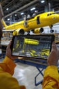 using Tablet at Airplane Maintenance Hangar with Augmented Reality, Technological Royalty Free Stock Photo