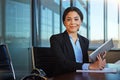 Using a tablet helps to keep clutter at bay. a businesswoman taking notes while using her tablet. Royalty Free Stock Photo