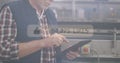 Using tablet, man in industrial setting with social media likes image overlay Royalty Free Stock Photo
