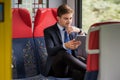 Using tablet on a train Royalty Free Stock Photo