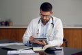 Using technology to improve your health. a handsome male doctor working on his tablet while sitting in his office. Royalty Free Stock Photo