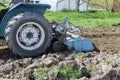 Using a tractor milling machine loosens and grinds soil before planting.
