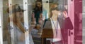 Using virtual reality headset, woman exploring data center image over server racks