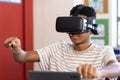Using VR headset, boy in school engaging with virtual reality experience Royalty Free Stock Photo