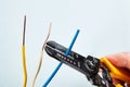 Using wire stripper cutter during electrical wiring installati Royalty Free Stock Photo