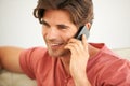Using wireless technology to stay connected. A handsome young man talking to someone on his cellphone. Royalty Free Stock Photo