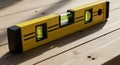 Using Yellow Level Tool on Wood Surface for Precise Measurement Royalty Free Stock Photo