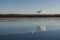 Usma, Latvia - February 11, 2017: A personal plane lands on the ice of Lake Usma in winter