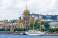 Uspensky temple on the bank of the Neva river and a sailboat near the embankment.