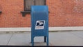 Blue USPS Mailbox in front of Brick Wall Royalty Free Stock Photo