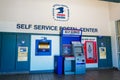 USPS self service postal center with self service kiosk and collection boxes located inside United States Post office