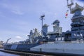 The USS North Carolina with guns and people walking on the deck of the ship and a gorgeous blue sky at Battleship North Carolina Royalty Free Stock Photo