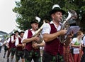 Usseln, Germany - July 30th, 2018 - Bavarian marching band in traditional dress playing brass instruments at a parade