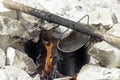 USSR army pot of water hanging on a stick over a fire