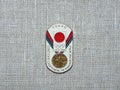 Metal badge with the image of the Olympic medal and the inscription `Soviet athletes at the Olympics, Tokio-1964`