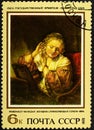 USSR - CIRCA 1973: A stamp printed in the USSR shows painting Young woman trying earrings by artist Rembrandt, stamp