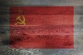 USSR flag on rustic old wood surface red yellow hammer sickle CCCP