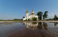 Ust-Kuda, Irkutskaya oblast, Russia - July 5 2020: Old Orthodox church with reflection in a puddle