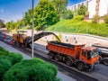 Usti nad Labem, Czech republic - 5.22.2018: Milling machine removes old asphalt from the road and transports it to a truck