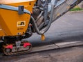 Usti nad Labem, Czech republic - 5.22.2018: Road milling machine - a closer look at the belt moving slowly forward