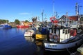 Ustka, Pomerania, Poland - Ustka fishing port with cutters and peers at the Baltic Sea shoreline Royalty Free Stock Photo
