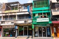 The usual street of the Asian city. Multi-colored low buildings and motorbikes