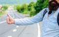 Usually use thumb up to inform drivers hitchhiking. But in some cultures gesture offensive so you risk to be killed by Royalty Free Stock Photo