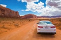 Kia Optima car and red rock of Monument Valley. Navajo Tribal Park landscape Royalty Free Stock Photo