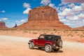 Off-road car and famous red rock of Monument Valley. Navajo Tribal Park landscape Royalty Free Stock Photo