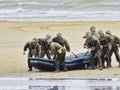 Special forces men in camouflage uniforms out army kayak on the beach .Remembrance of D-Day liberty in France during world war two Royalty Free Stock Photo