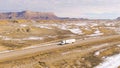 AERIAL: Walmart truck hauls cargo across the Utah desert on a sunny winter day.