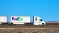 CLOSE UP FedEx truck speeds along an interstate highway crossing the Utah desert Royalty Free Stock Photo