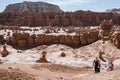 Utah, USA - May 14, 2021: Hikers climb up slickrock after hiking in the hoodoos of Goblin Valley State Park