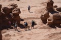 Hikers walk down into the bizarre hoodoos of Goblin Valley State Park in Utah Royalty Free Stock Photo