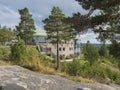 UTANSJO, SWEDEN - August 21, 2019: view on rounded building of Hotel Hoga Kusten between pine trees next High coast bridge