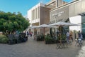 Outdoor shopping center with upmarket chain retailers, a movie theater, restaurants.