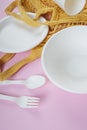 Utensil made of plastic and paper over pink background Royalty Free Stock Photo