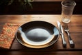 Utensils rest beside an empty plate, ready for a meal