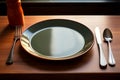 Utensils rest beside an empty plate, ready for a meal