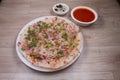Uthappam or Uttapam is a type of dosa from southern India that is thicker, with tomato, onion, chilli packets
