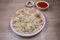 Uthappam or Uttapam is a type of dosa from southern India that is thicker, with tomato, onion, chilli packets and cheese Royalty Free Stock Photo